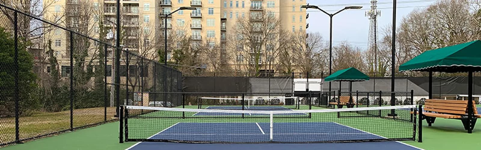 A multi-court outdoor pickleball complex with several games in progress